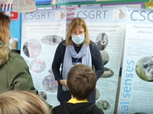 Photo showing SRT banners and volunteer talking to pupils