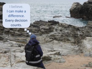 Photo of person looking out to sea with a caption 'I can make a difference'