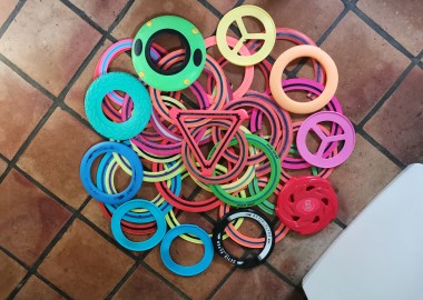 Photo of over 30 flying rings to show their range of colours and styles