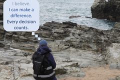 Photo of person looking out to sea with a caption 'I can make a difference'